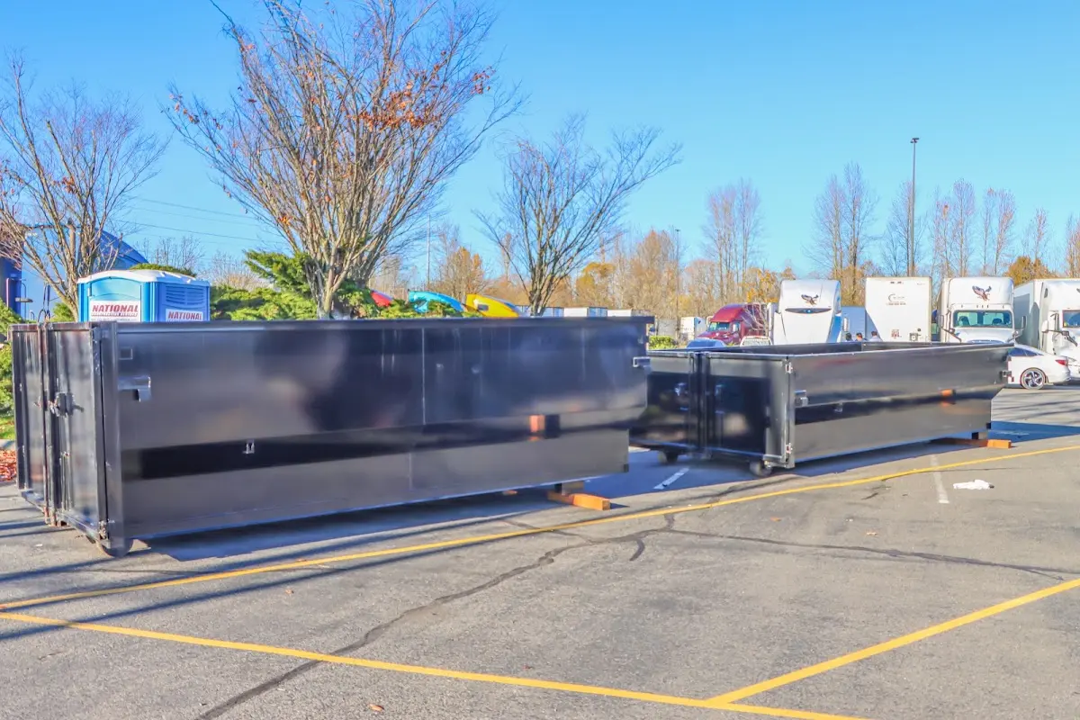 Professional dumpster rental service with roll-off container on residential driveway in Uvalde